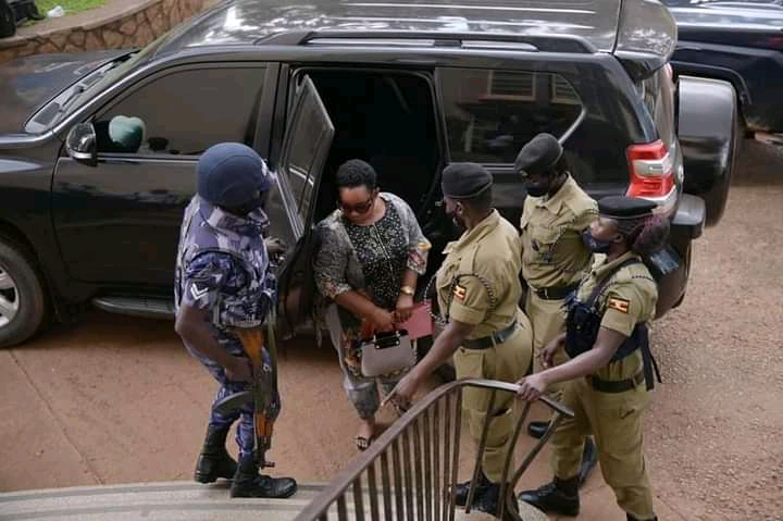 Omumbejja Bwanga sorrounded by officers as she arrived at the CPS in Kampala. She was arrested August 26 in Luweero. Courtesy photo