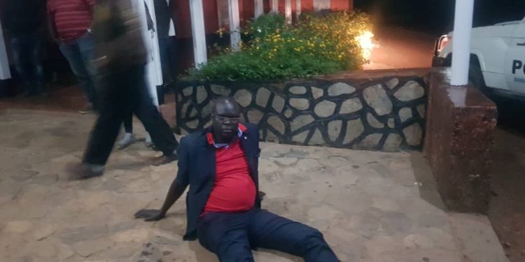 The Chief magistrate of Kapchorwa court, Godfrey Teko who is also the son of State minister Peter Lokeris sits on the ground after he was arrested.