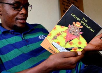 Kakwenza holds his controversila book-The Barbarian.